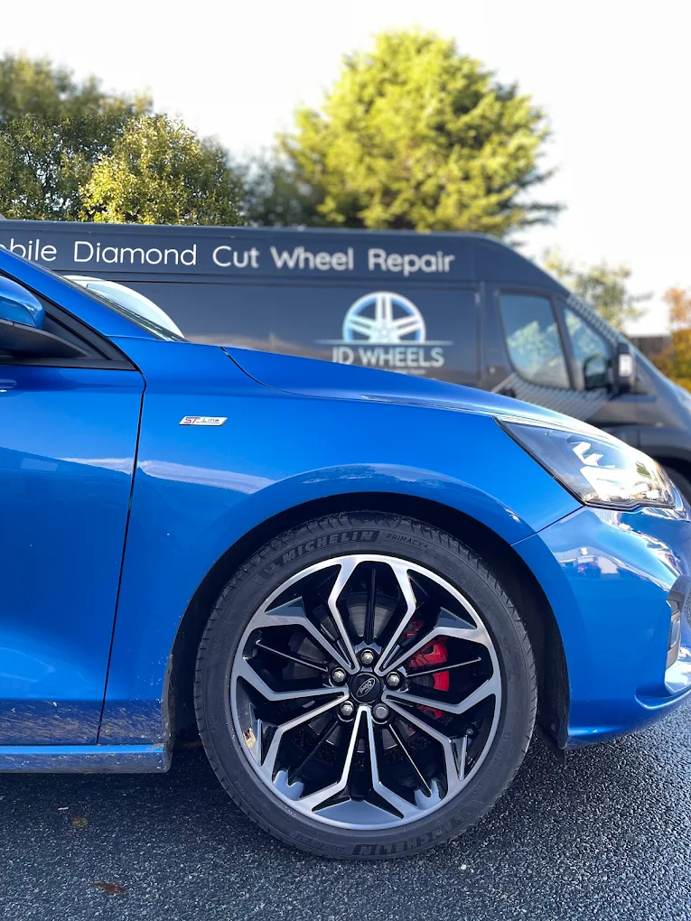 Grey alloy wheel with a machined silver face fitted to a car