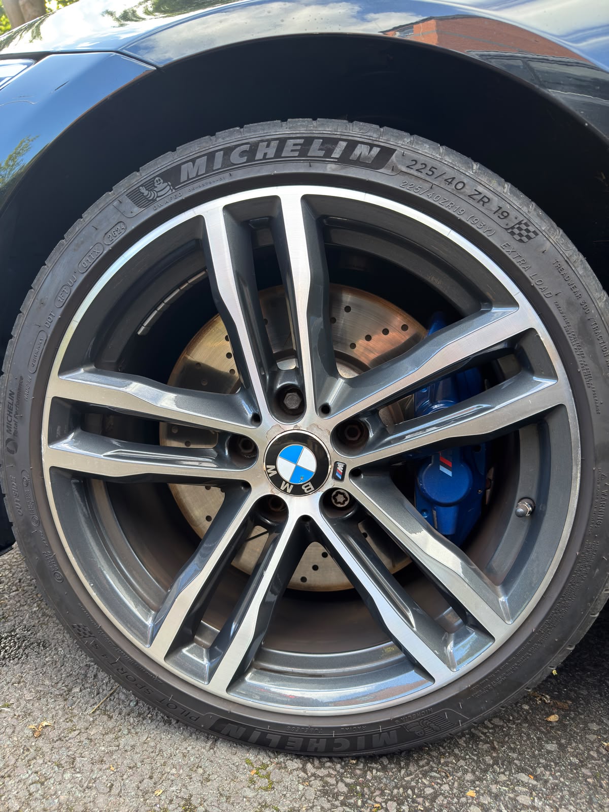 BMW alloy wheel with a machined face and blue brake caliper