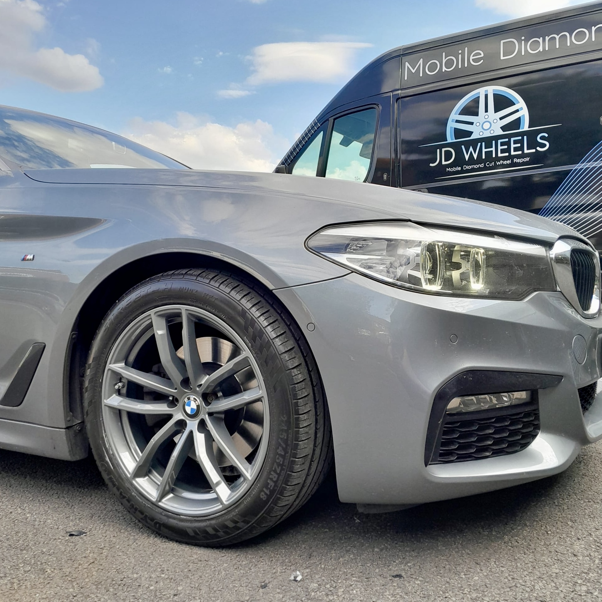 Grey BMW beside the JD Wheels mobile diamond cutting van