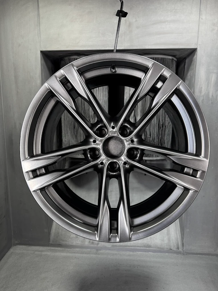 Grey alloy wheel with a diamond cut face and red brake caliper